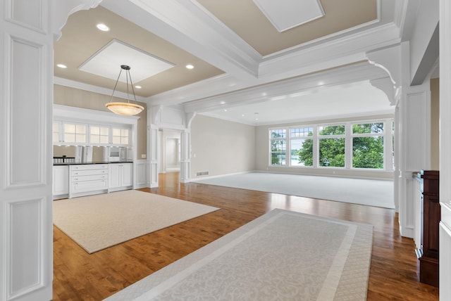 1505 Edgewater Ave, Arden Hills, MN 55112 - unfurnished living room featuring decorative columns, ornamental molding, wood finished floors, and recessed lighting