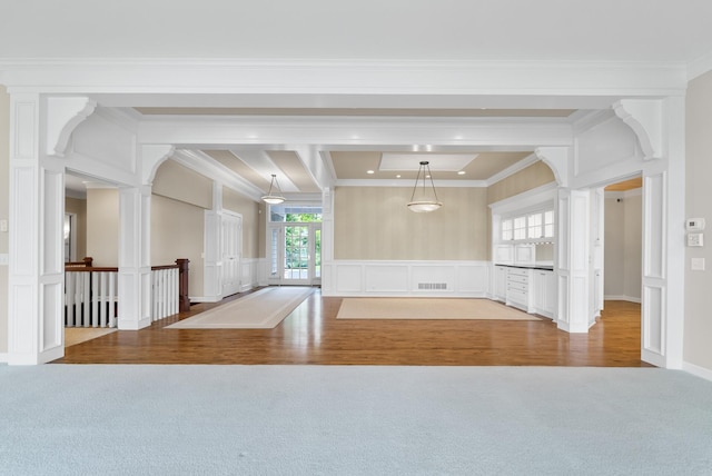 1505 Edgewater Ave, Arden Hills, MN 55112 - carpeted empty room featuring crown molding, a decorative wall, wood finished floors, and a wainscoted wall