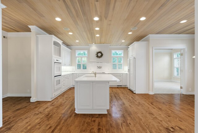 1505 Edgewater Ave, Arden Hills, MN 55112 - kitchen with wood ceiling, recessed lighting, crown molding, paneled refrigerator, and a center island with sink