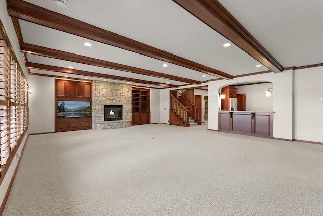1505 Edgewater Ave, Arden Hills, MN 55112 - unfurnished living room with beam ceiling, light carpet, arched walkways, stairs, and a fireplace