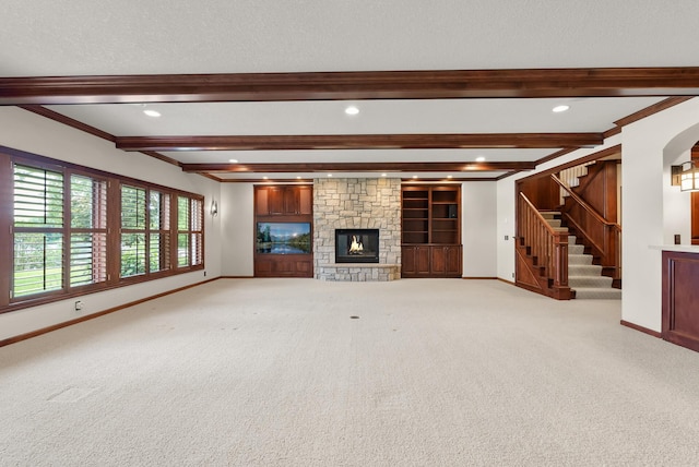 1505 Edgewater Ave, Arden Hills, MN 55112 - unfurnished living room featuring carpet, beam ceiling, a stone fireplace, stairway, and ornamental molding