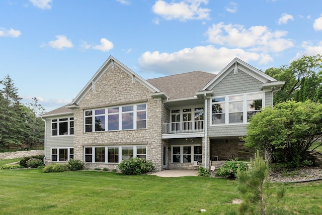 1505 Edgewater Ave, Arden Hills, MN 55112 - rear view of house with stone siding, a patio area, a yard, and a shingled roof