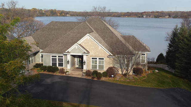 1505 Edgewater Ave, Arden Hills, MN 55112 - view of front of property with stone siding, a water view, and a shingled roof