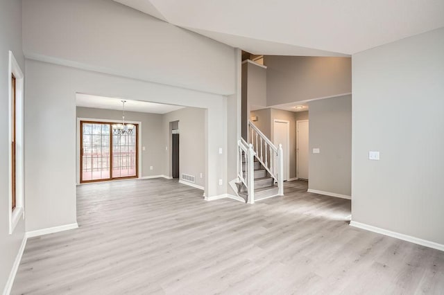 5298 Park Dr, Savage, MN 55378 - unfurnished living room featuring a notable chandelier, light wood-style floors, and baseboards