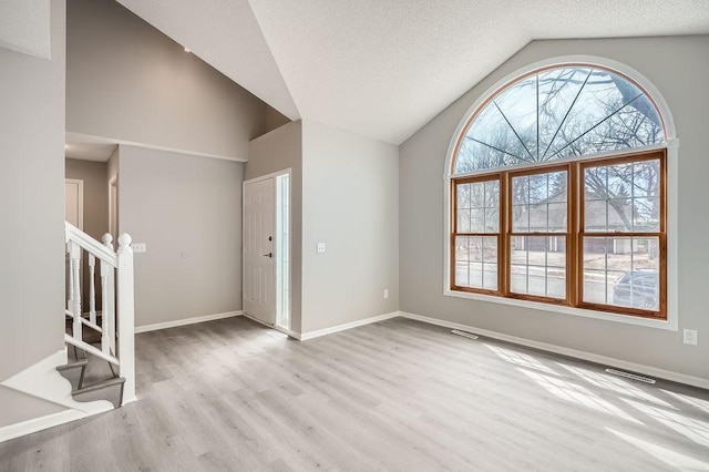 5298 Park Dr, Savage, MN 55378 - unfurnished living room featuring visible vents, a textured ceiling, wood finished floors, baseboards, and stairs