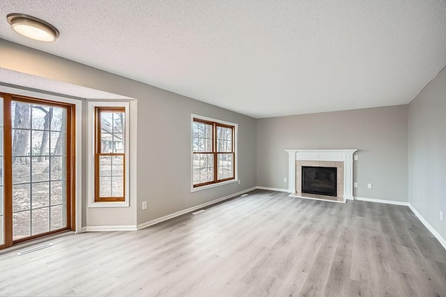 5298 Park Dr, Savage, MN 55378 - unfurnished living room with wood finished floors, baseboards, and a textured ceiling