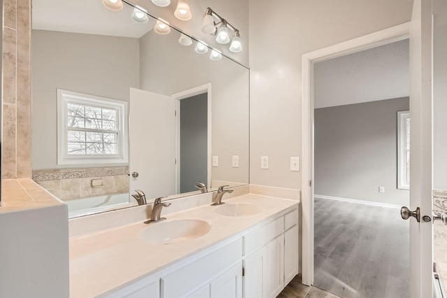 5298 Park Dr, Savage, MN 55378 - full bath featuring double vanity, wood finished floors, baseboards, and a sink