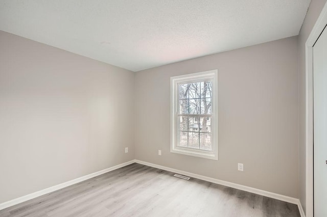 5298 Park Dr, Savage, MN 55378 - interior space featuring visible vents, wood finished floors, baseboards, and a textured ceiling