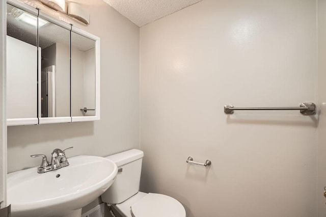 5298 Park Dr, Savage, MN 55378 - half bath with a textured ceiling, toilet, and a sink