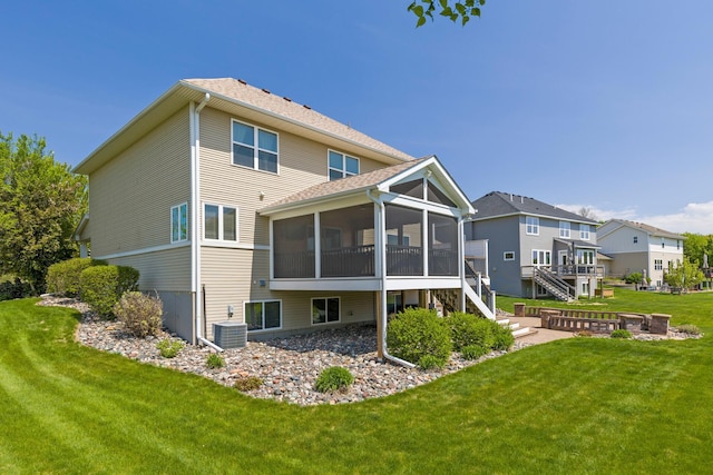 back of house with a sunroom, stairway, a lawn, and cooling unit