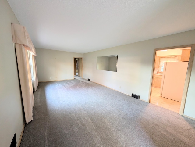 empty room with carpet flooring and baseboards