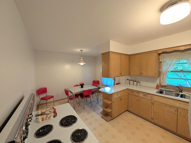 kitchen with a sink, light flooring, light countertops, a peninsula, and white range with electric cooktop