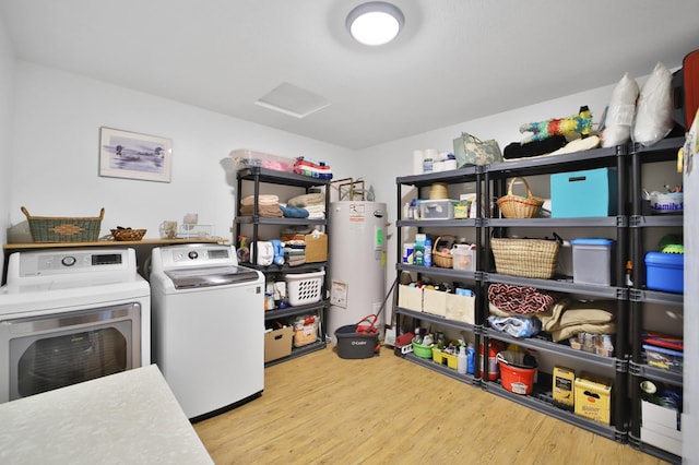 1572 44th St SW, Pine River, MN 56474 - laundry area featuring washing machine and clothes dryer, water heater, wood finished floors, and attic access