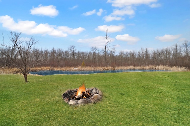 1572 44th St SW, Pine River, MN 56474 - view of grassy yard with a water view, a fire pit, and a wooded view