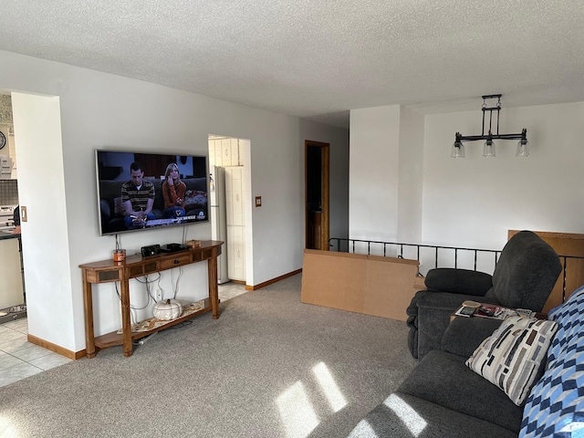 carpeted living area featuring baseboards and a textured ceiling