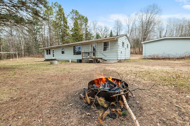 rear view of house with an outdoor fire pit