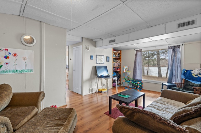 living room with visible vents and light wood-style flooring