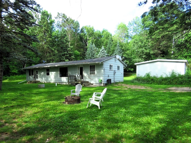 201 27 1/4 26 7/8 Avenue A, Cumberland, WI 54829 - rear view of house featuring a yard and a fire pit
