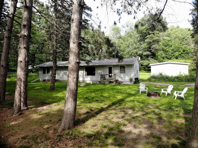 201 27 1/4 26 7/8 Avenue A, Cumberland, WI 54829 - rear view of property featuring an outdoor fire pit and a lawn