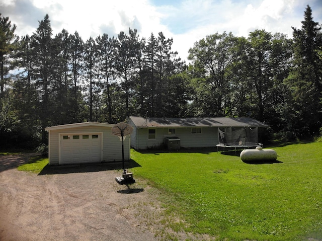 201 27 1/4 26 7/8 Avenue A, Cumberland, WI 54829 - single story home with dirt driveway, a trampoline, an outbuilding, a front yard, and a garage