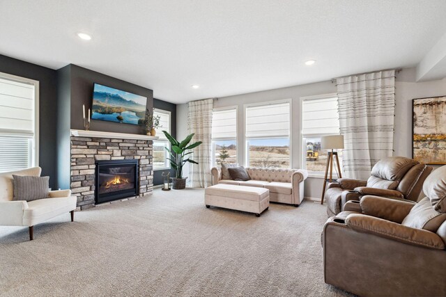 carpeted living room featuring recessed lighting, a fireplace, and baseboards