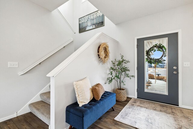 entrance foyer with stairway, wood finished floors, and baseboards