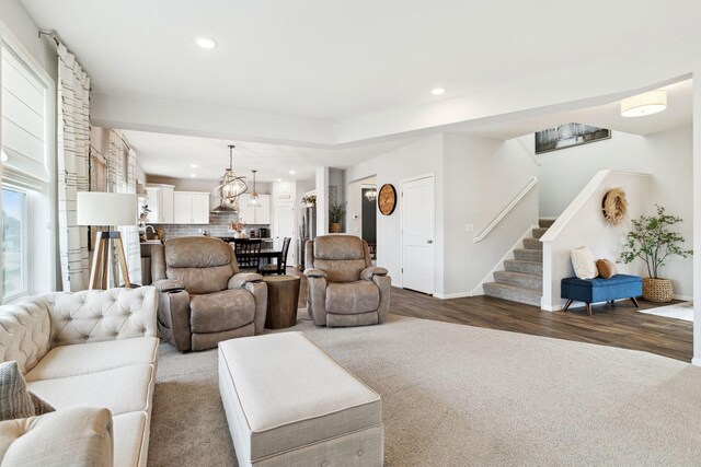 living area with stairway, wood finished floors, baseboards, carpet floors, and recessed lighting