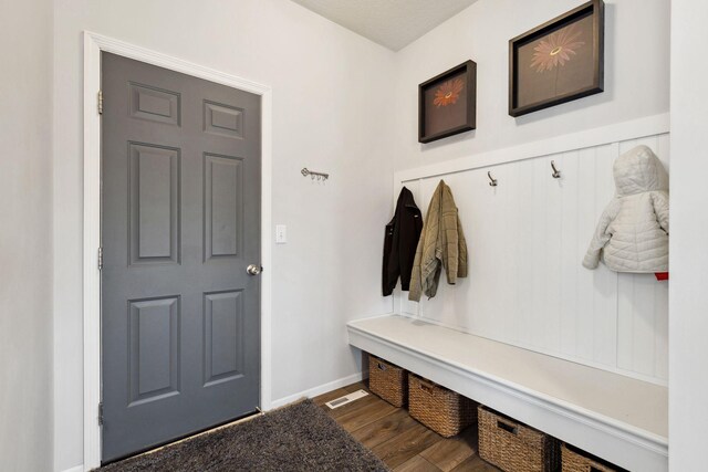 mudroom featuring baseboards and wood finished floors