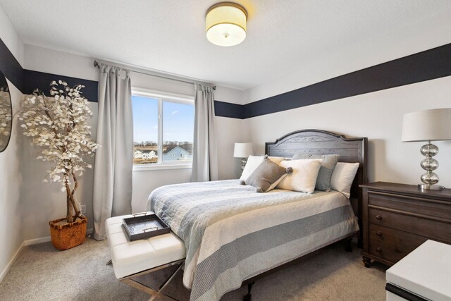 carpeted bedroom featuring baseboards