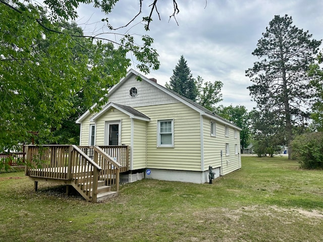 329 Main St NW, Menahga, MN 56464 - rear view of property featuring a deck and a lawn