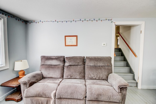 329 Main St NW, Menahga, MN 56464 - living area with baseboards, stairway, and wood finished floors