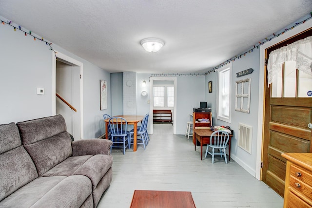 329 Main St NW, Menahga, MN 56464 - living area featuring hardwood / wood-style floors, stairs, and baseboards