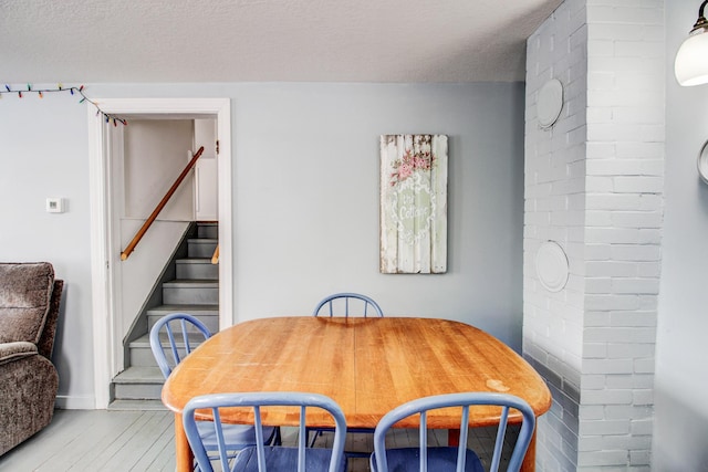 329 Main St NW, Menahga, MN 56464 - dining area with wood finished floors, stairs, and baseboards