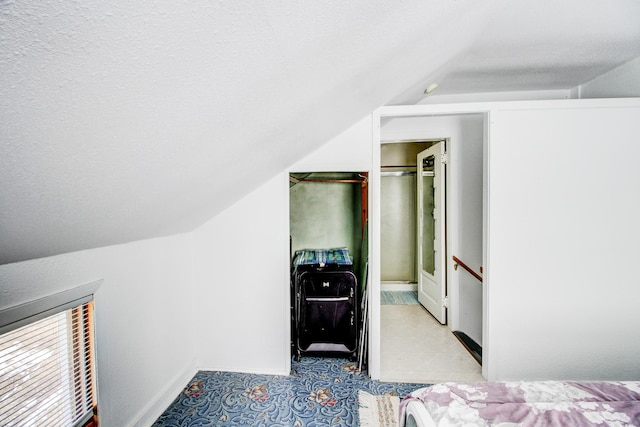 329 Main St NW, Menahga, MN 56464 - bedroom with vaulted ceiling, tile patterned floors, and baseboards