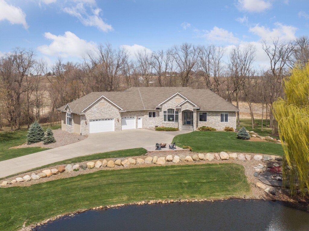 5290 Yvette St, Greenfield, MN 55357 - ranch-style house with a front lawn, driveway, stone siding, and an attached garage