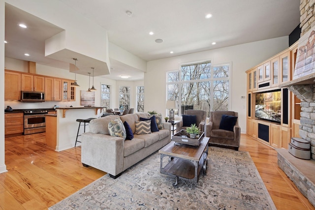 living room with recessed lighting and light wood-style floors