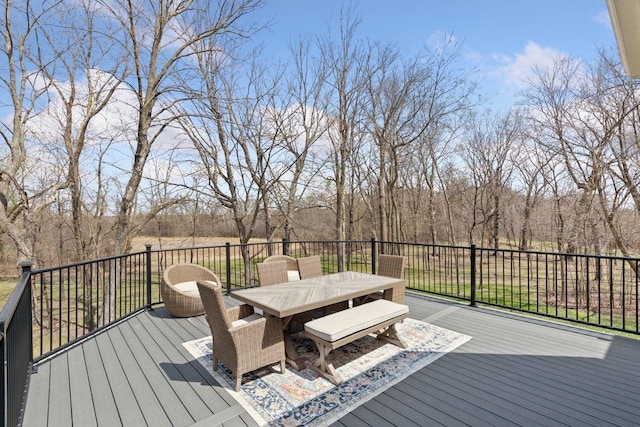 wooden terrace with outdoor dining space
