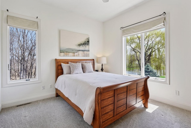 bedroom featuring visible vents, carpet floors, and baseboards