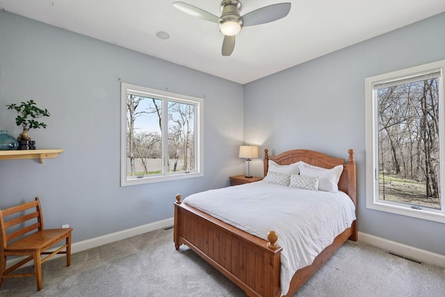 bedroom with baseboards, visible vents, and multiple windows