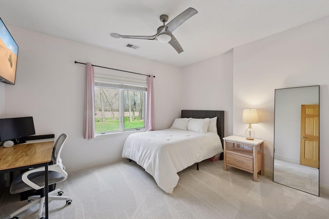 bedroom with a ceiling fan, visible vents, light colored carpet, and baseboards