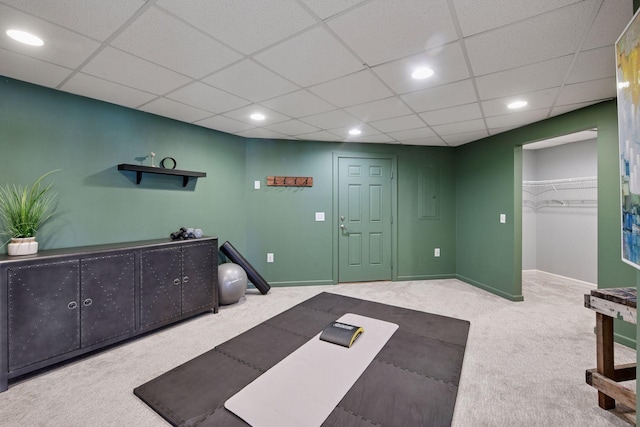 interior space with recessed lighting, a paneled ceiling, carpet, and baseboards