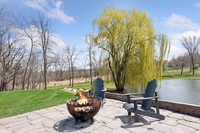 view of patio / terrace featuring an outdoor fire pit and a water view