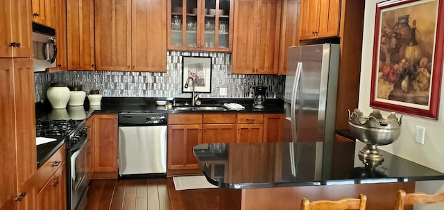 5250 Grandview Sq Unit 2406, Edina, MN 55436 - kitchen with glass insert cabinets, a sink, dark countertops, stainless steel appliances, and tasteful backsplash