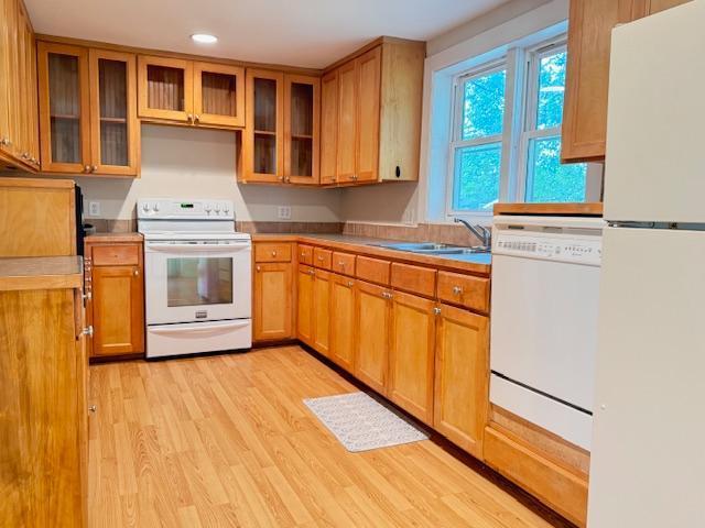 222 Dogwood Ave NW, Menahga, MN 56464 - kitchen featuring white appliances, light wood-style flooring, light countertops, recessed lighting, and glass insert cabinets