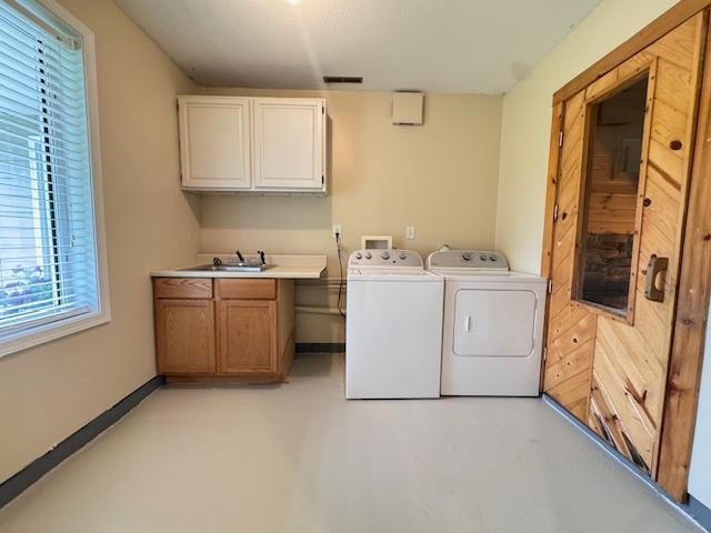 222 Dogwood Ave NW, Menahga, MN 56464 - washroom with cabinet space, independent washer and dryer, and plenty of natural light