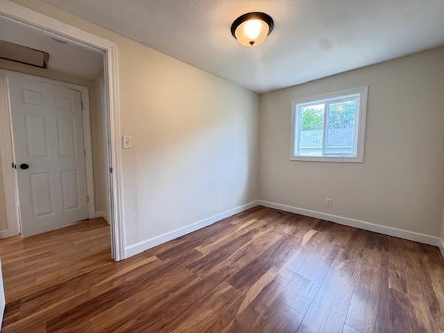 222 Dogwood Ave NW, Menahga, MN 56464 - spare room featuring wood finished floors and baseboards