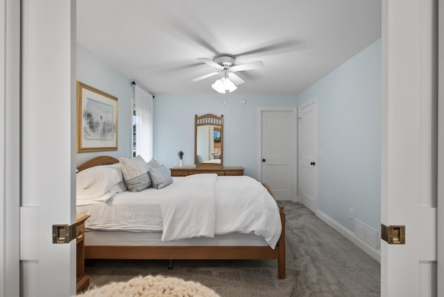 carpeted bedroom featuring baseboards, ceiling fan, and visible vents
