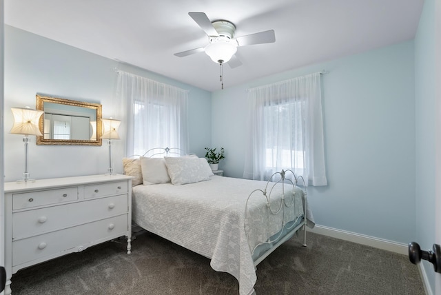 bedroom with baseboards, a ceiling fan, and dark colored carpet