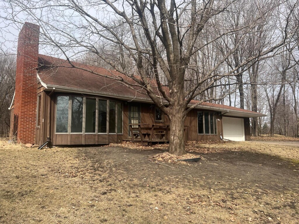185 Hackberry Hl, Orono, MN 55356 - view of front facade featuring an attached garage, board and batten siding, and a chimney