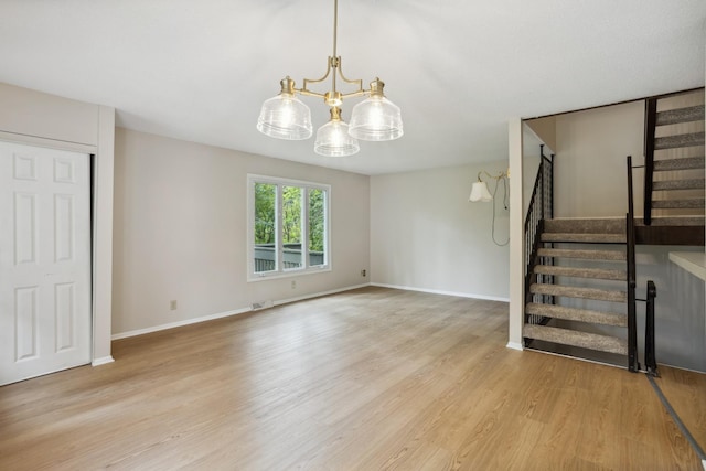 4854 Grenwich Trl N, Oakdale, MN 55128 - unfurnished living room featuring a chandelier, stairway, and wood finished floors